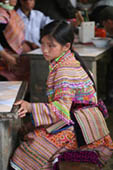 Hmong Girl sitting at the market by Annie Muto